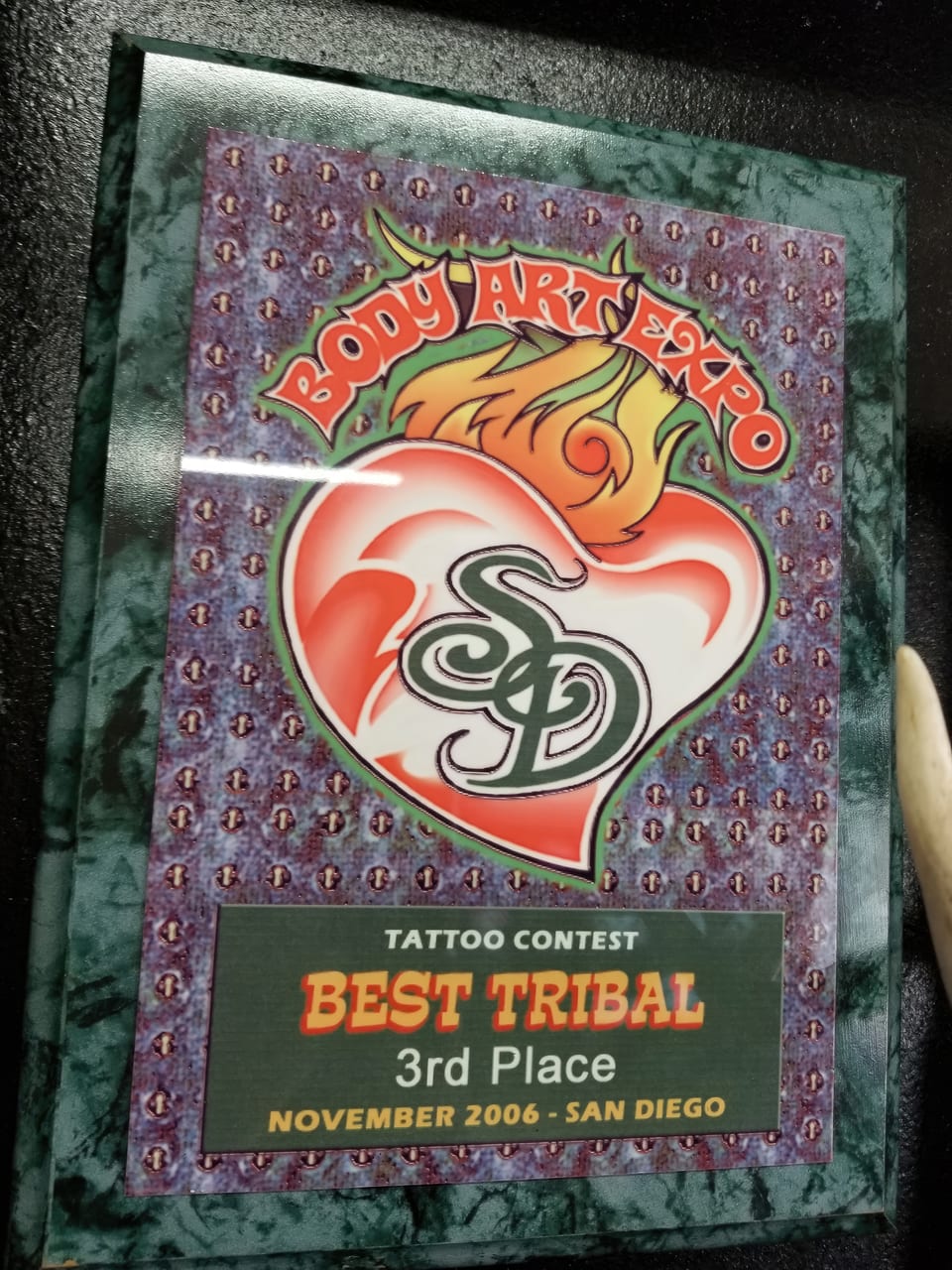 A framed Body Art Expo plaque reads "Best tribal, 3rd place."