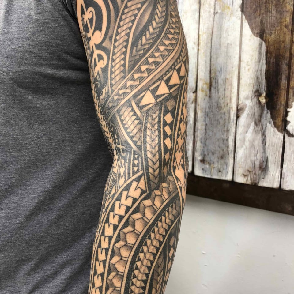 Polynesian full sleeve with fine geometric patterns on a man's arm, tattooed by Seth Reynolds